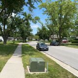 A photo of an Ames neighborhood with one of the city's distribution transformers in the foreground.