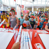 Visitors picking up posters at the ISU exhibit at the Iowa State Fair