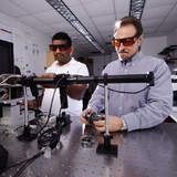 Valery Levitas, right, and Sorb Yesudhas prepare a rotational diamond anvil cell for an experiment.