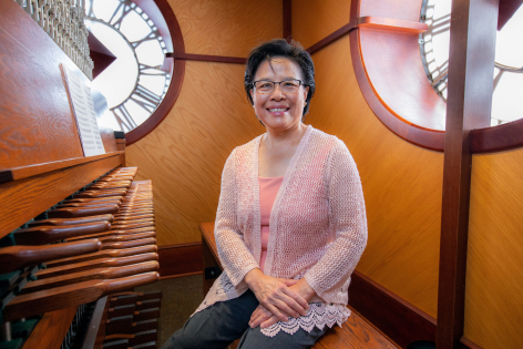 Tin-Shi Tam sitting at the carillon inside the Campanile