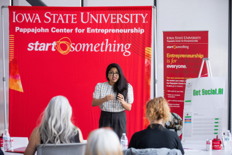 Student presenting to judges in pitch competition