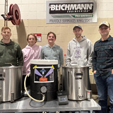 Winning team members standing in brewing science lab