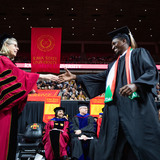 President Wintersteen congratulates students at fall 2023 commencement in Hilton Coliseum. 