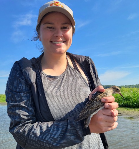 Victoria Fasbender holding a tagged pectoral sandpiper